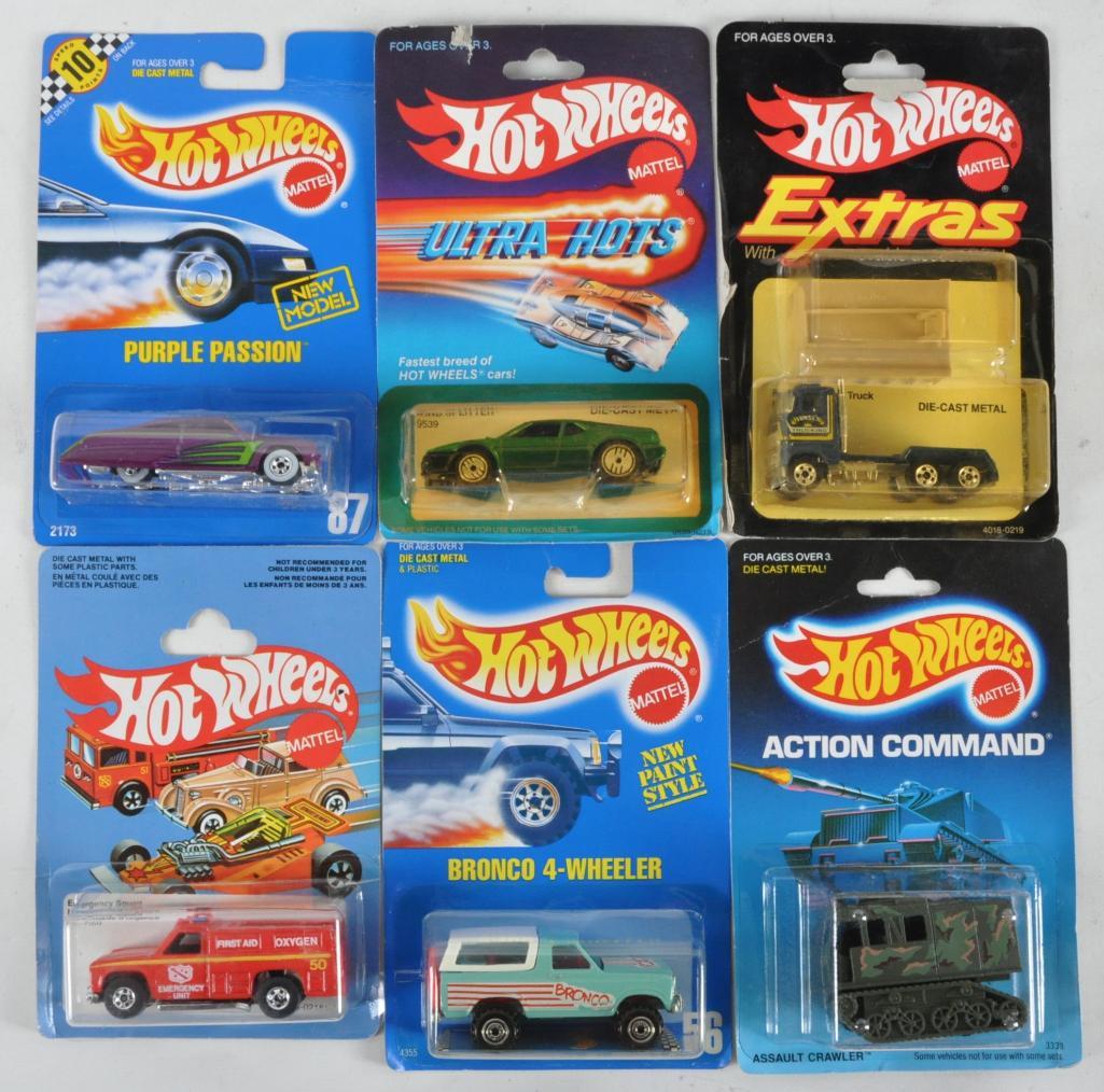 Group of 6 Hot Wheels Die-Cast Vehicles in Original: Includes Assault Crawler, Bronco 4-Wheeler, Emergency Squad, Ford Stake Bed Truck, Wind Splitter, and Purple Passion, New in Original Packaging