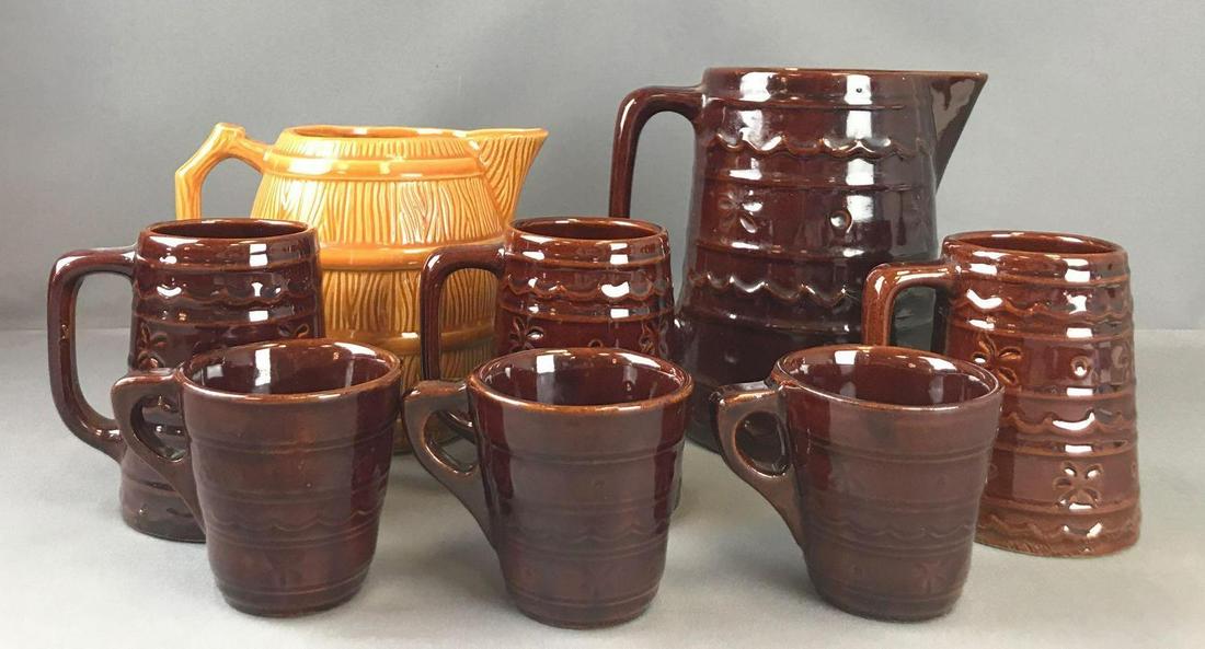 Group of 8 pieces pottery pitchers and mugs: Brown set is Marcrest. Pitcher is 8.25 inches. Orange is R.R.P.Co.-6.75 inches