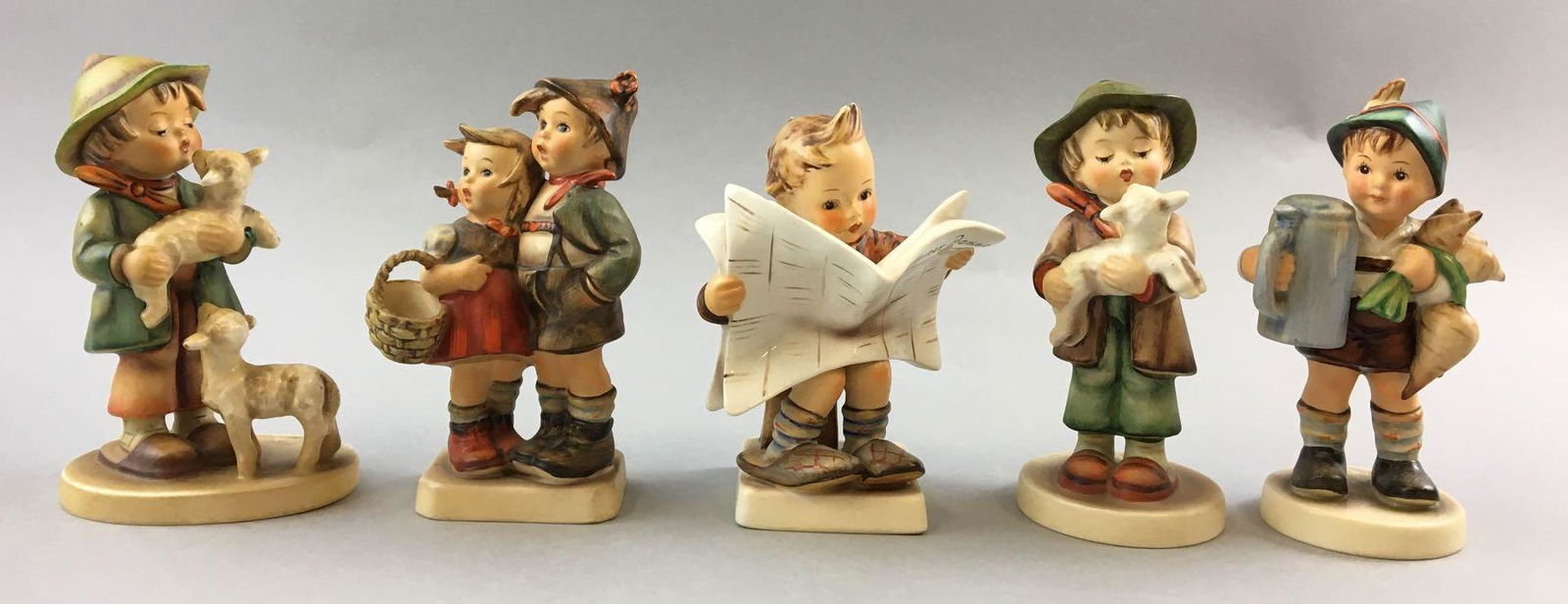 Group of 5 Vintage Goebel Hummels: Includes the lost sheep, boy with newspaper, boy gardener and more, W. Germany, 5 1/2 inches tall