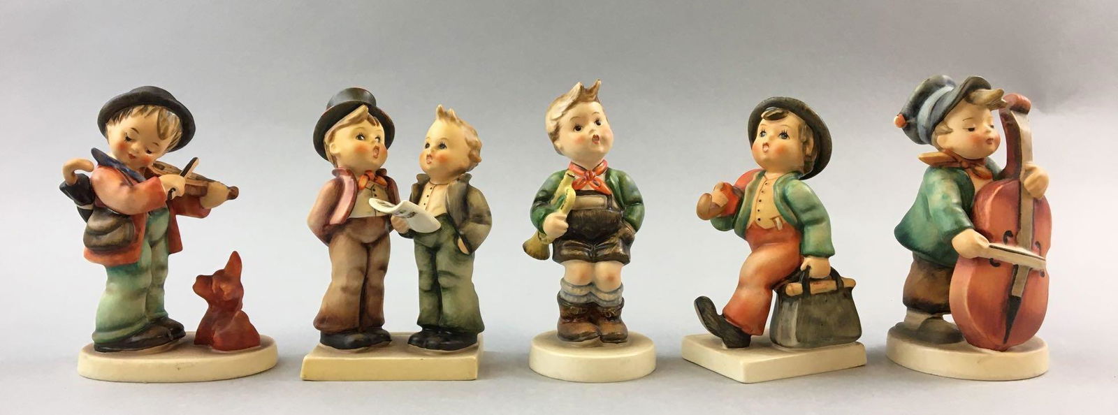 Group of 5 Vintage Goebel Hummels: Includes puppy love, trumpet boy, duet, merry wanderer, and sweet music, W. Germany, all 5 inches tall