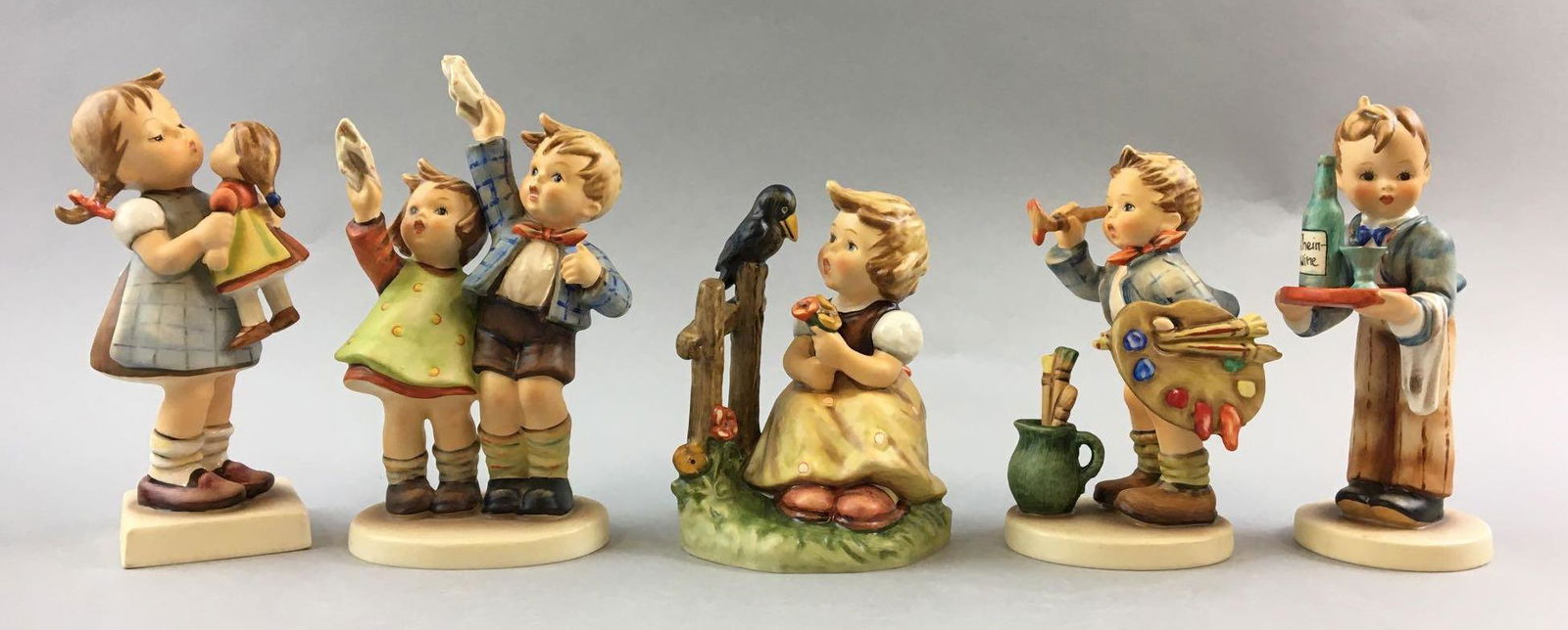 Group of 5 Vintage Goebel Hummels: Includes kiss me, Auf Wiedersehen, sing with me gefallens dir, artist and server, W. Germany, largest is 6 1/2 inches tall