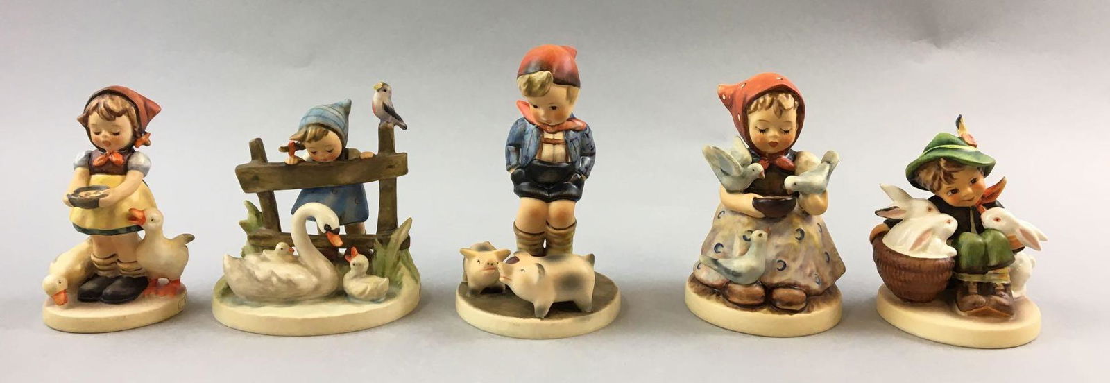 Group of 5 Vintage Goebel Hummels: Includes feathered friends, playmates, farm boy with pigs and more, W. Germany, largest is 5 inches tall
