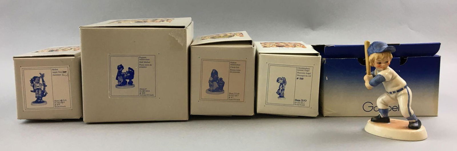 Group of 5 Vintage Goebel Hummels In Original Boxes: Includes chick girl, Apple tree boy, doll mother, heavenly angel, and batter up, largest is 5 inches tall