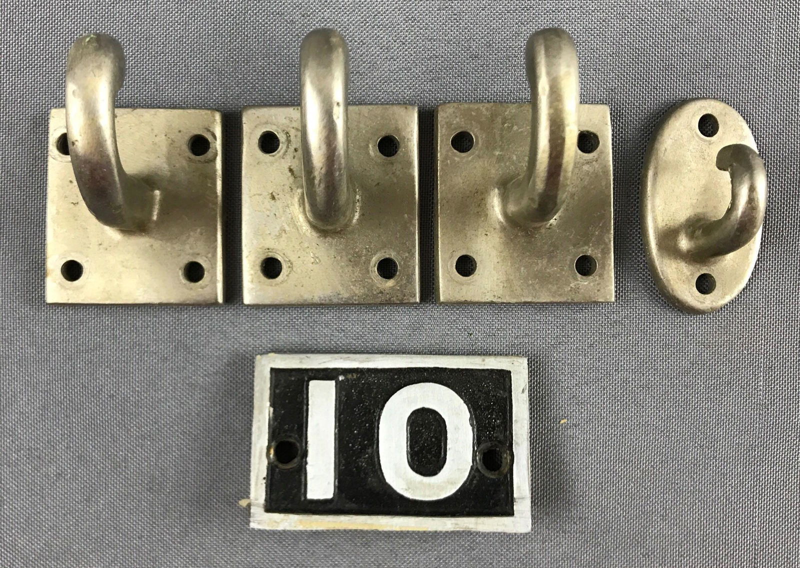 Group of Vintage Pullman metal train car coat hooks: Plus metal number 10. 10 is 2.25x1.5 inches