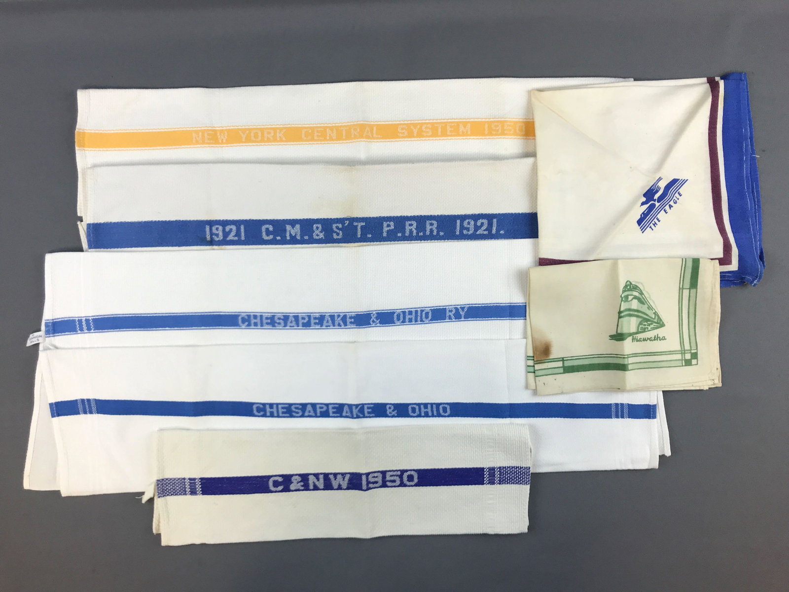 Group of 7 vintage railroad linens: 5 towels. Includes New York central system 1950, Chesapeake and Ohio, C and NW 1950, and more. Some minor wear and discoloration from age/use. Largest is 26.5x17