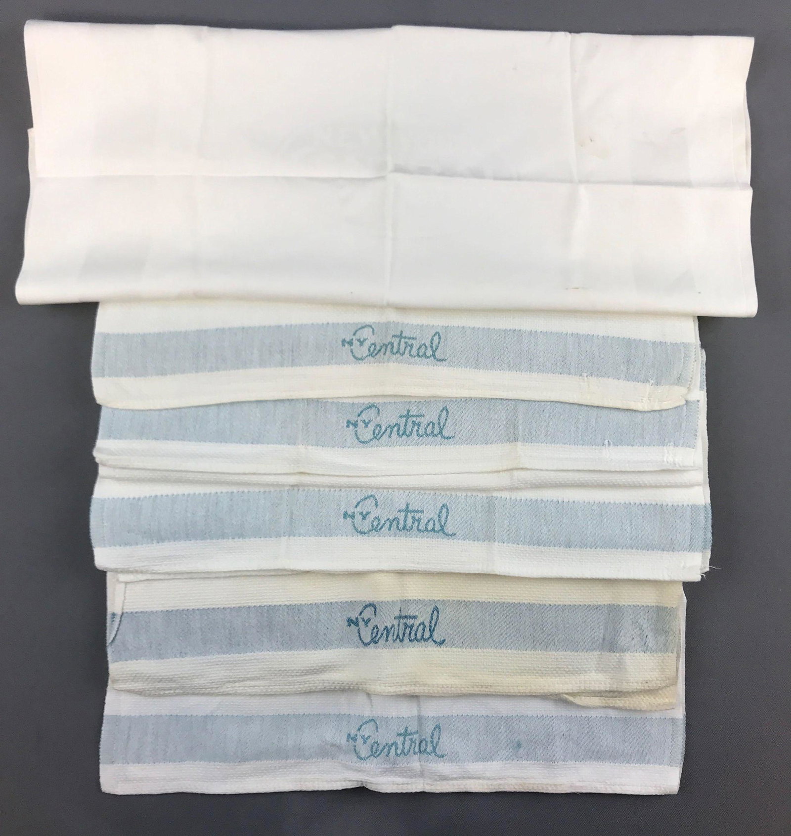 Group of 6 vintage New York Central Linens: 5 towels, one napkin. Some wear/discolor or stains. Napkin is 19x17.5 inches