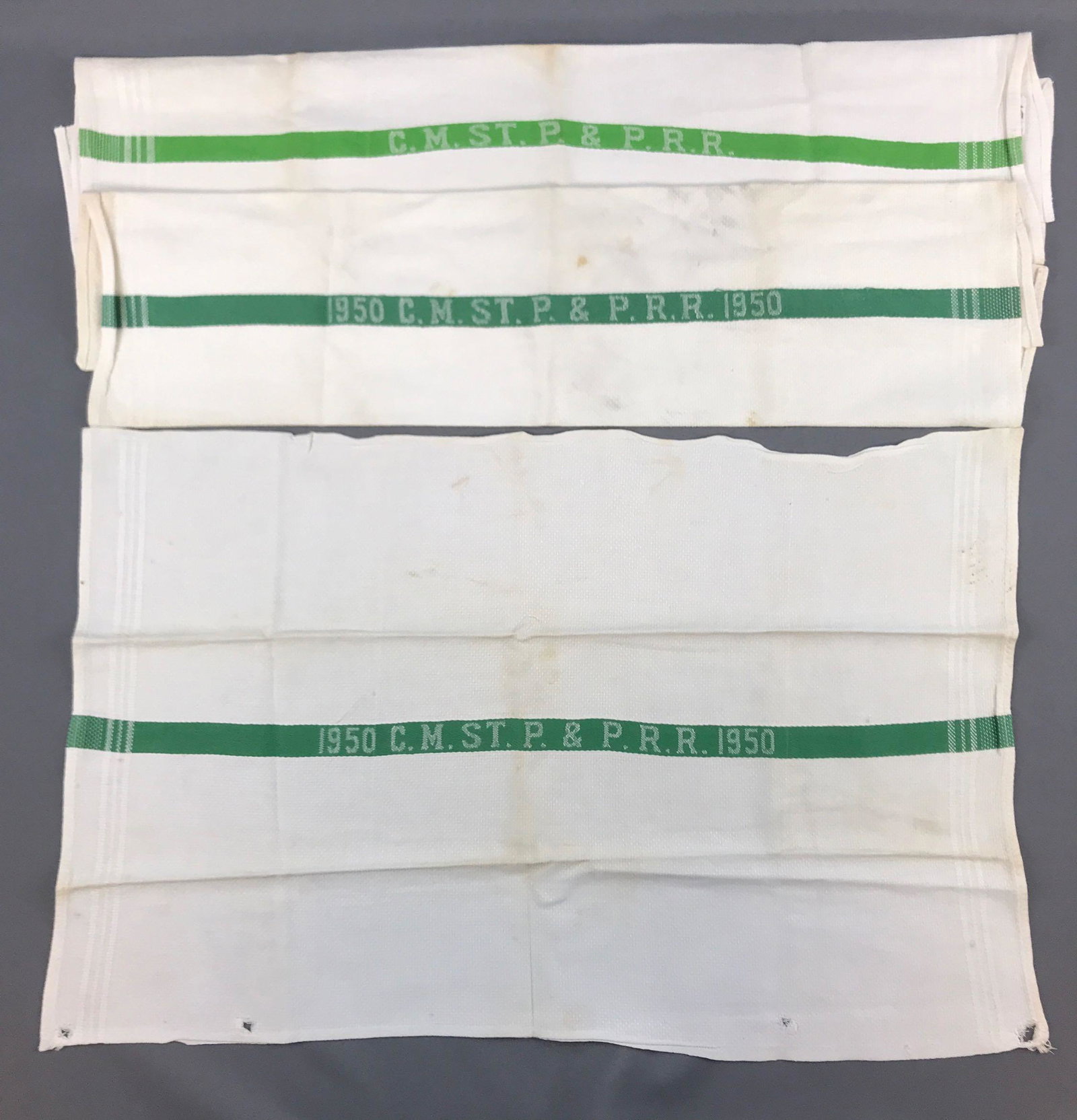 Group of 3 vintage Railroad towels: CM ST P & P, 2 are dated 1950. Some stains and holes. 23x15 inches