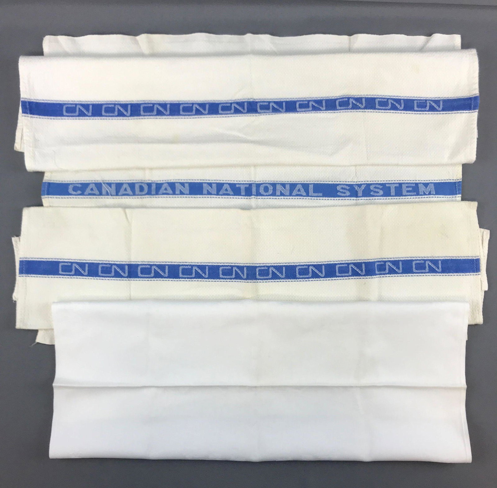 Group of 4 Canadian National System railroad linens: 3 towels, one napkin. Napkin is 20x20 inches. Some stains/discoloration