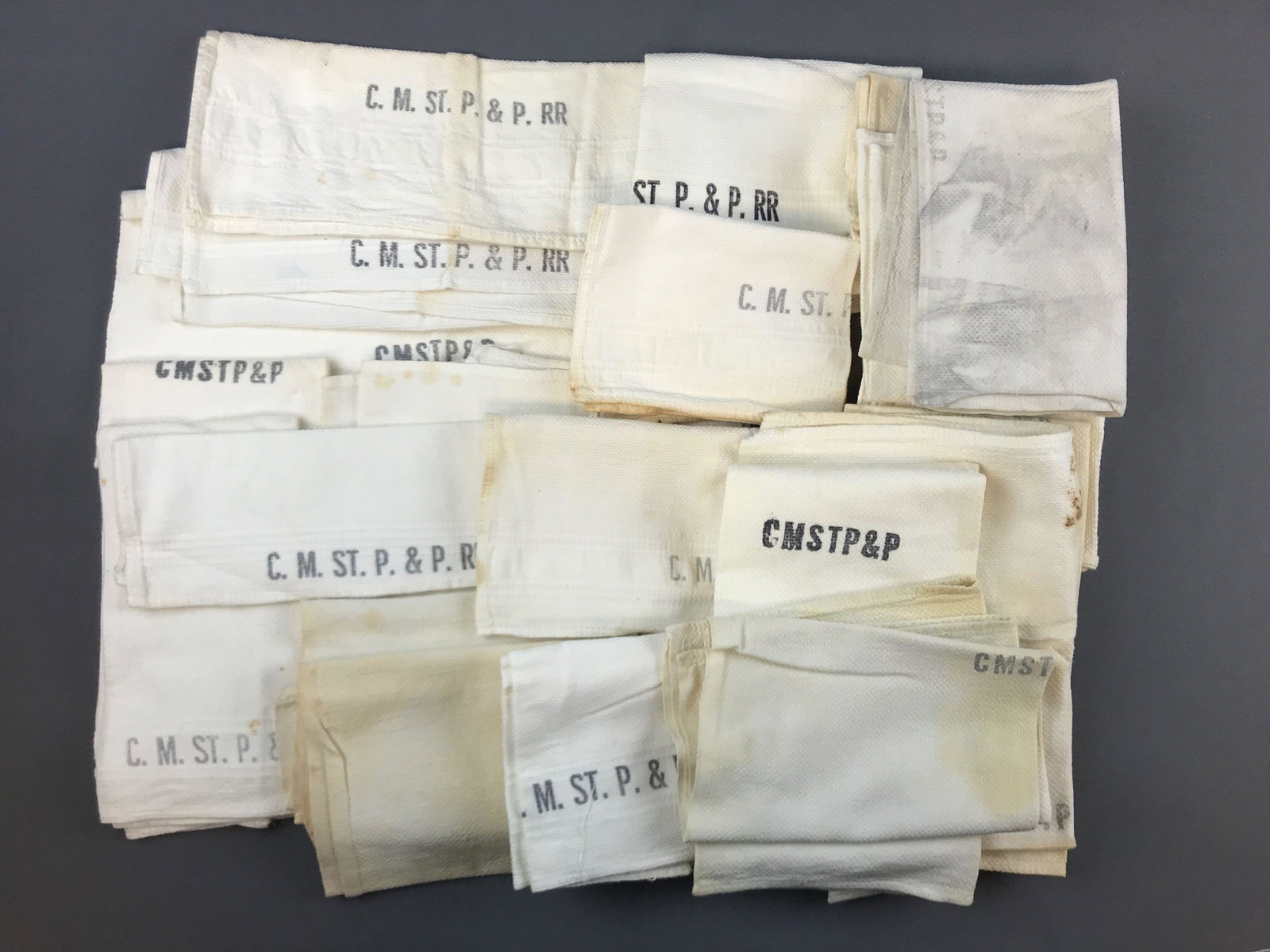 Group of vintage CMSTP&P railroad hand towels: Stains and wear.