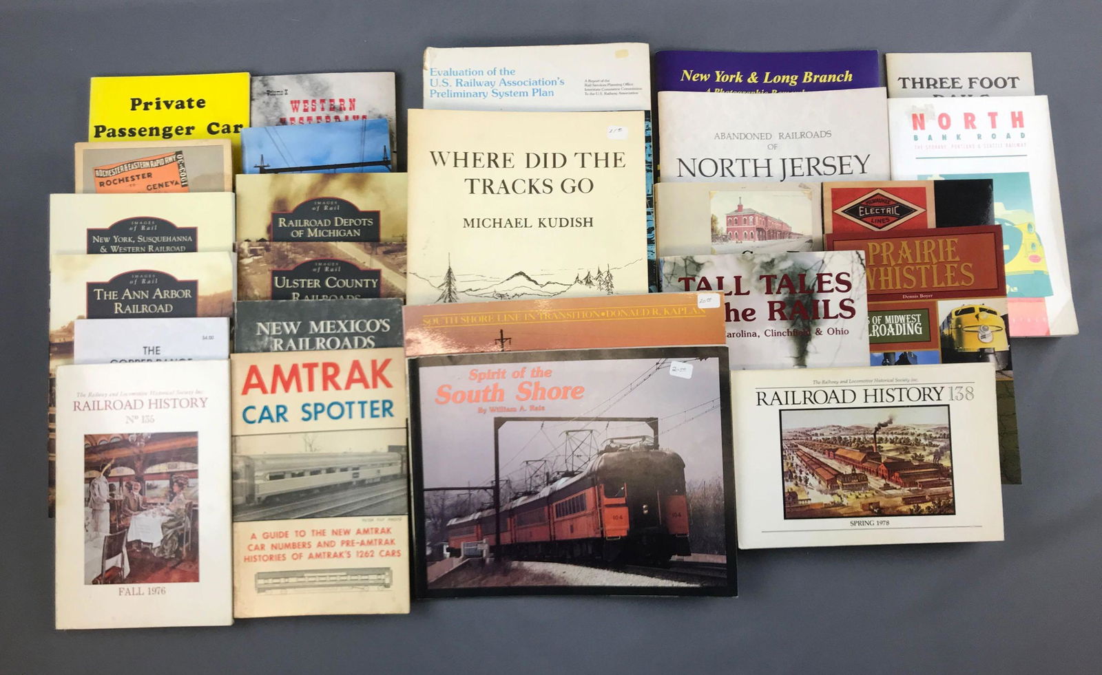 Group of railroad books: Amtrak car spotter, images of rail, railroad history, Milwaukee electric lines, and more