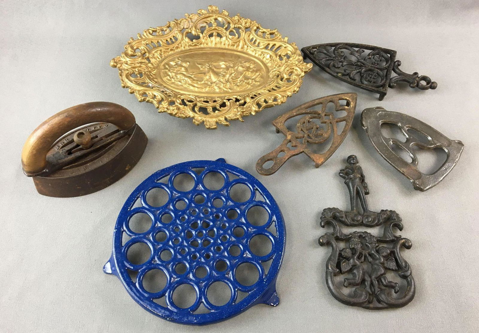 Group of 7 Iron Trivets and more: Includes sad iron, iron art decor and trivets, largest is 12 x 9 1/2 inches