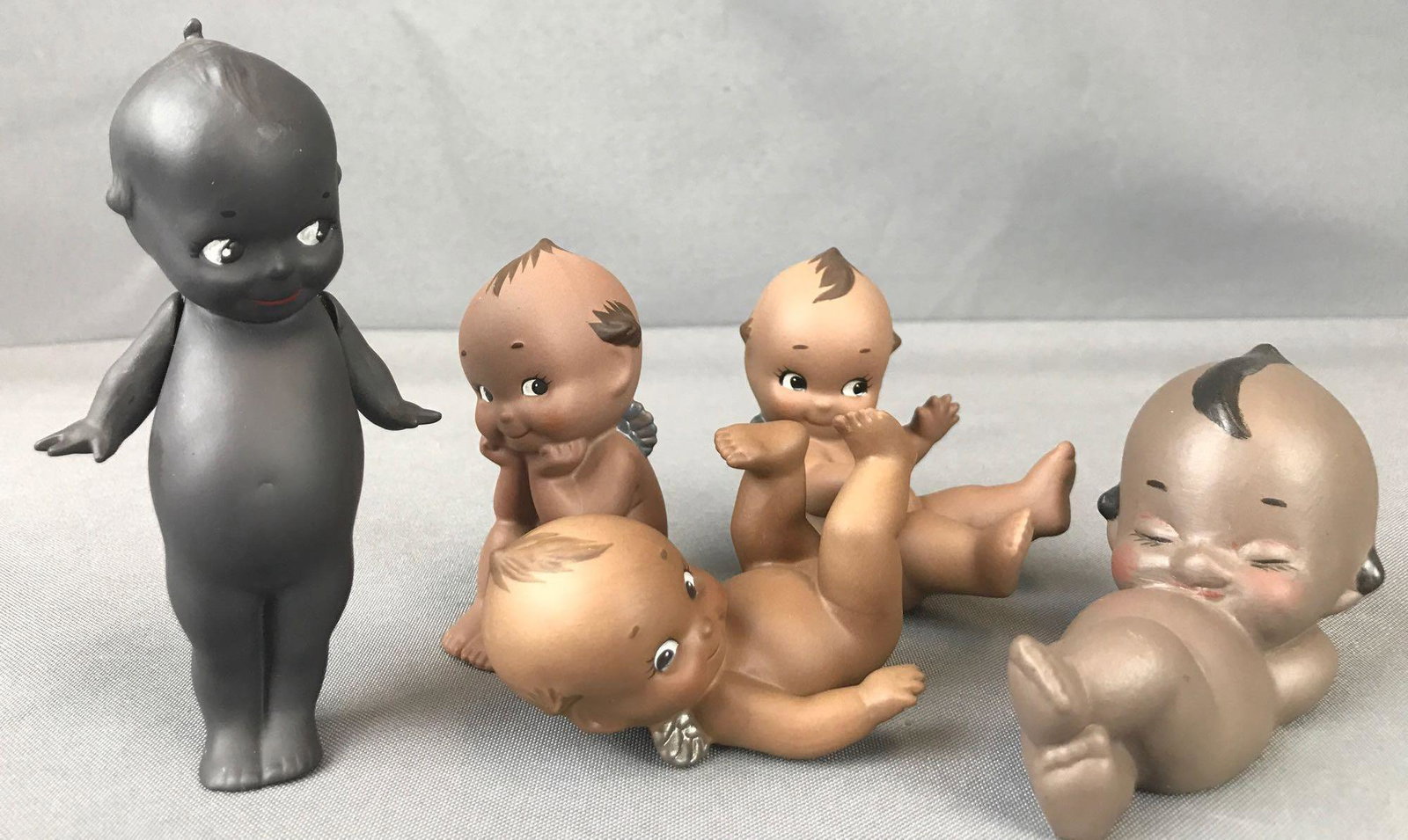Group of 5 Porcelain Black Kewpie figurines: Largest is 4.75 inches. Standing, jointed Kewpie is a vintage, signed E. Joyce Baker handpainted figurine.