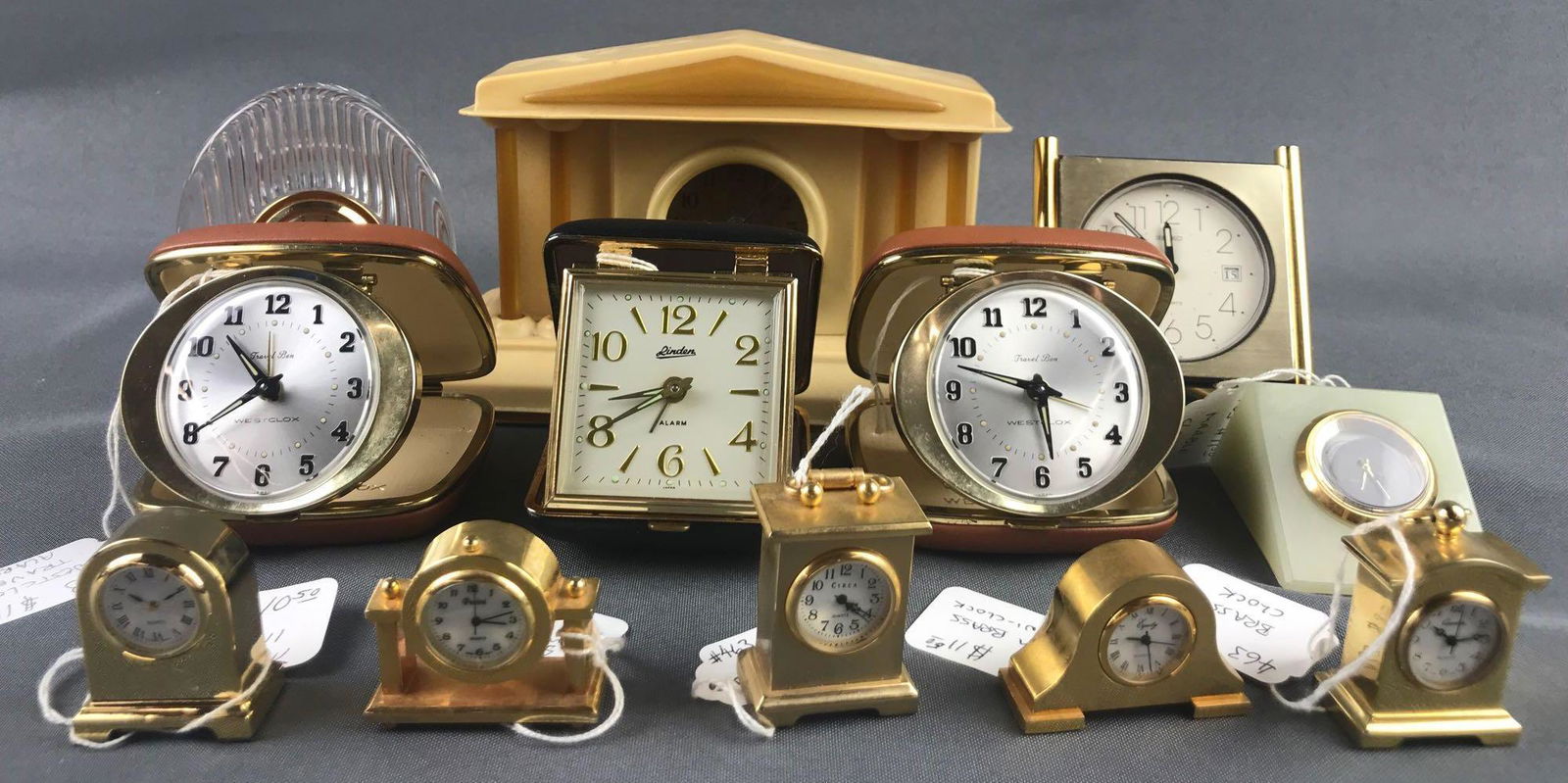 Group of 12 antique and vintage miniature and travel: Largest is 8x3.75x4.75 inches-Luxe Bakelite mantel clock, NON working condition. sorry no shipping on this lot.