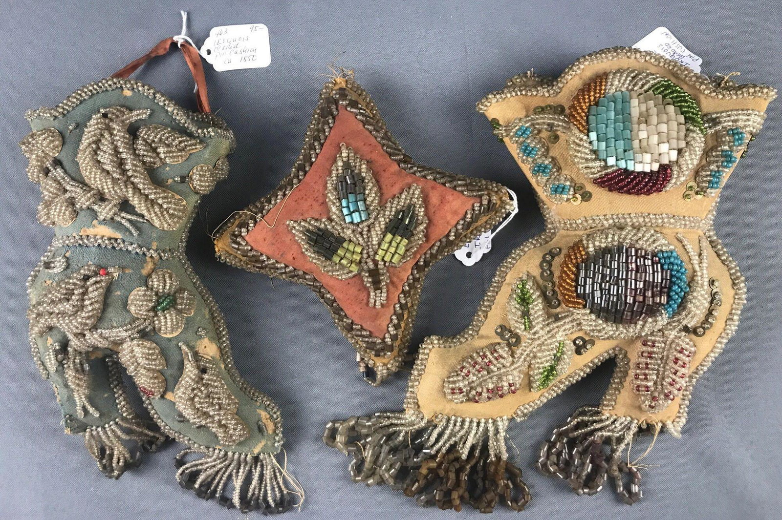 Group of 3 antique (1850s) Iroquois beaded pin cushions: Largest is 7x11 inches. Minor damage to all 3, loose thread, bare patches, missing beads.