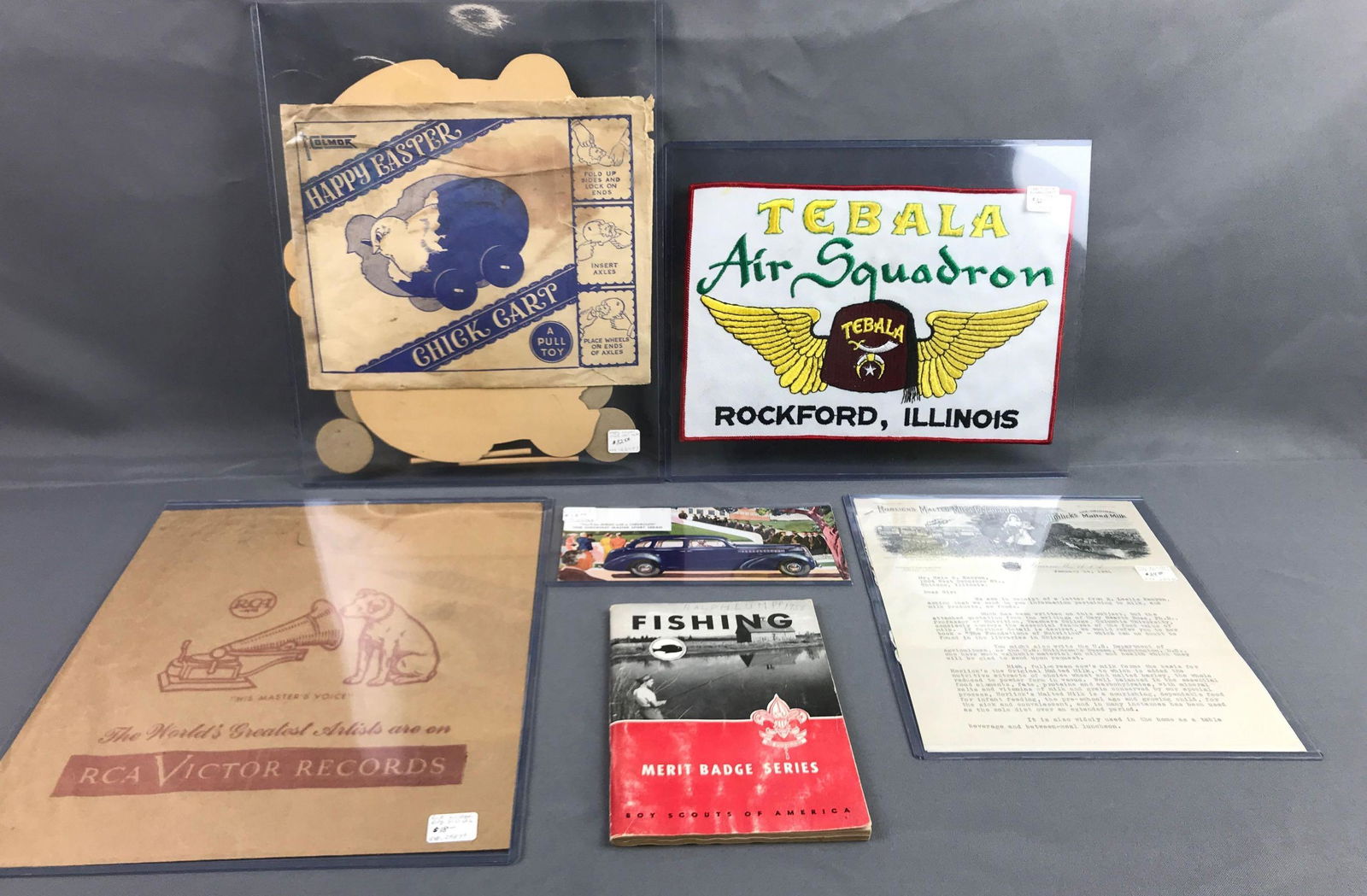 Group of 6 vintage toys: Easter pull toy air squadron jacket patch victor records bag manufacturers letter Chevy Sport booklet