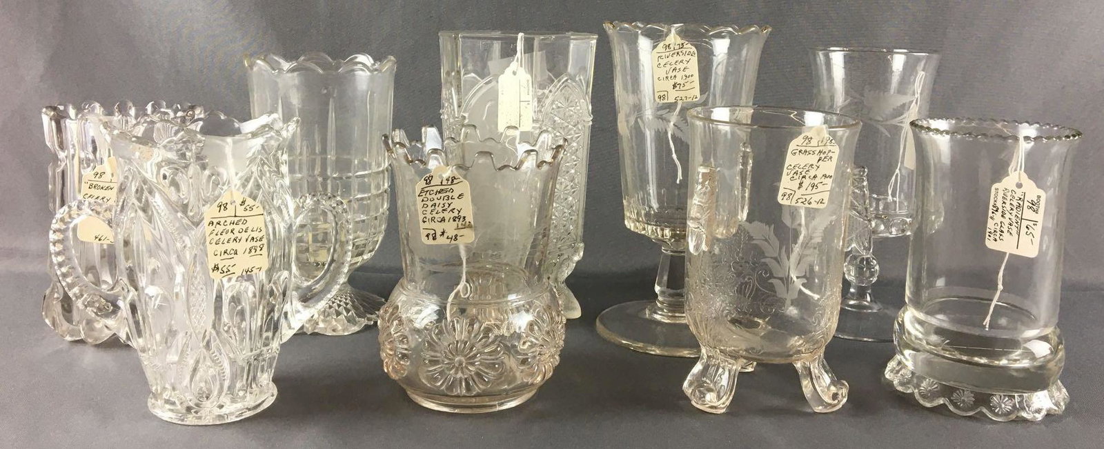 Group of 9 Antique Celery Vases: Circa early 1900s, etched Dakota, etched double Daisy, arched fleurdelis... and more, largest is 8 1/2 inches tall