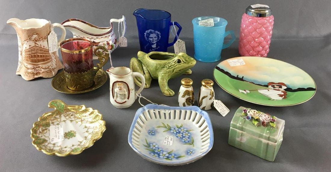 Group of Antique Miscellaneous Items: Includes Ruby flash cup with brass cup holder and saucer, frog, Fenton orange tree mug, Shirley Temple blue pitcher and more. Sorry no shipping on this lot.