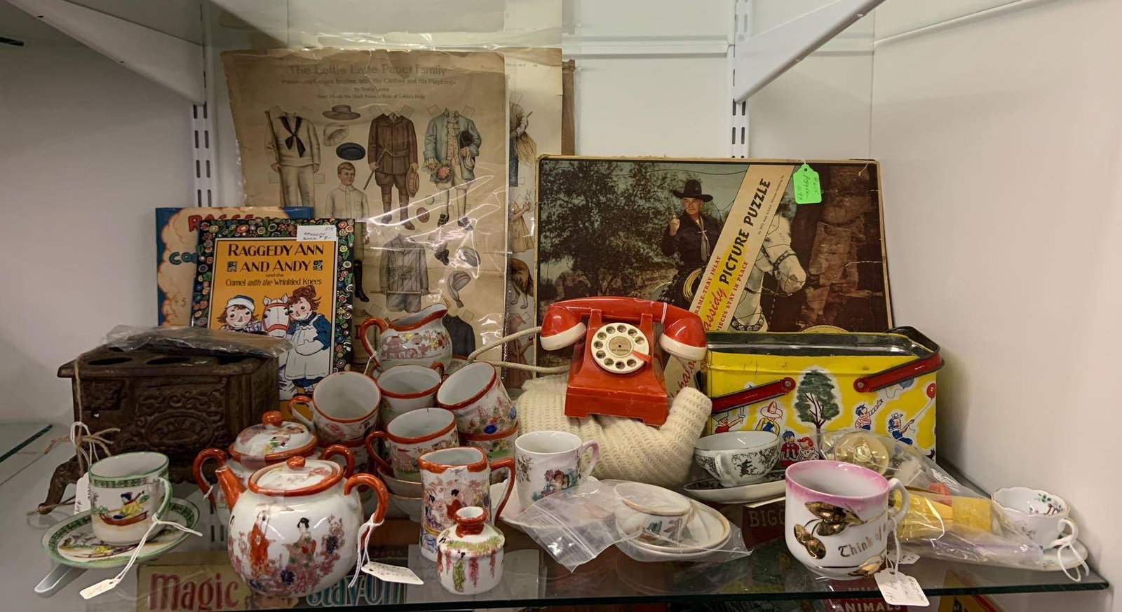 Shelf lot of antique and vintage doll accessories and: Includes hopalong Cassidy puzzle, paper dolls, T-shirt, and more