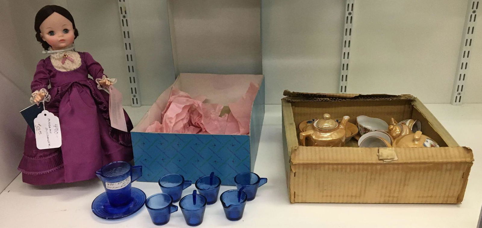 Shelf lot of Antique/Vintage Childs Tea Sets and Madame: Madame Alexander doll with original box, 8 pc. Blue Childs Pitcher with cups some chips and made in Japan little hostess Childs set