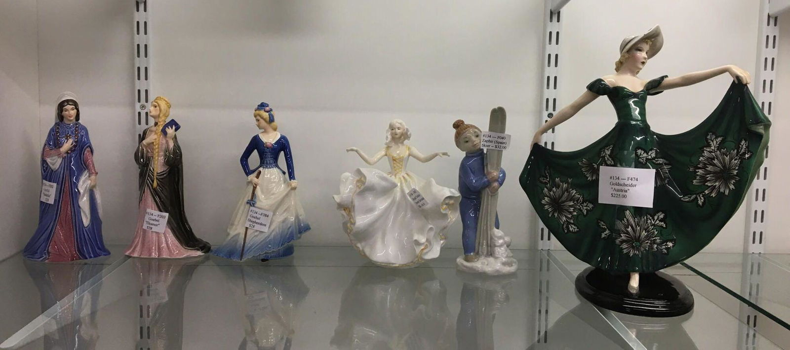 Shelf lot of 6 Vintage Figurines: Includes 3 Goebel women Eleanor, Isabella and Shepherdess, Royal dalton sweet seventeen, Goldscheider AUSTRIA and Zaphir skier, largest is 13 inches tall, she has a chip on her.