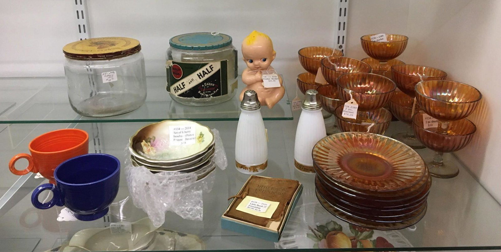 Shelf lot of Antique/Vintage Glassware and more: Sorry no shipping on this lot. Includes fiesta ware, carnival glass, tobacco jars, baby celluloid powder shaker, and more