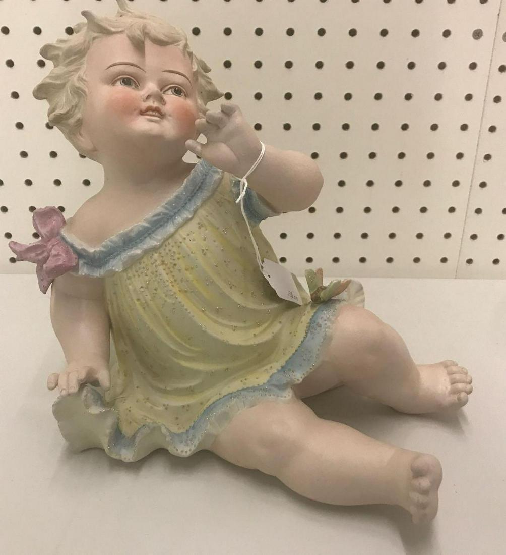 Vintage porcelain bisque Piano Baby: 10.5x10 inches. Small crack in fold of dress.
