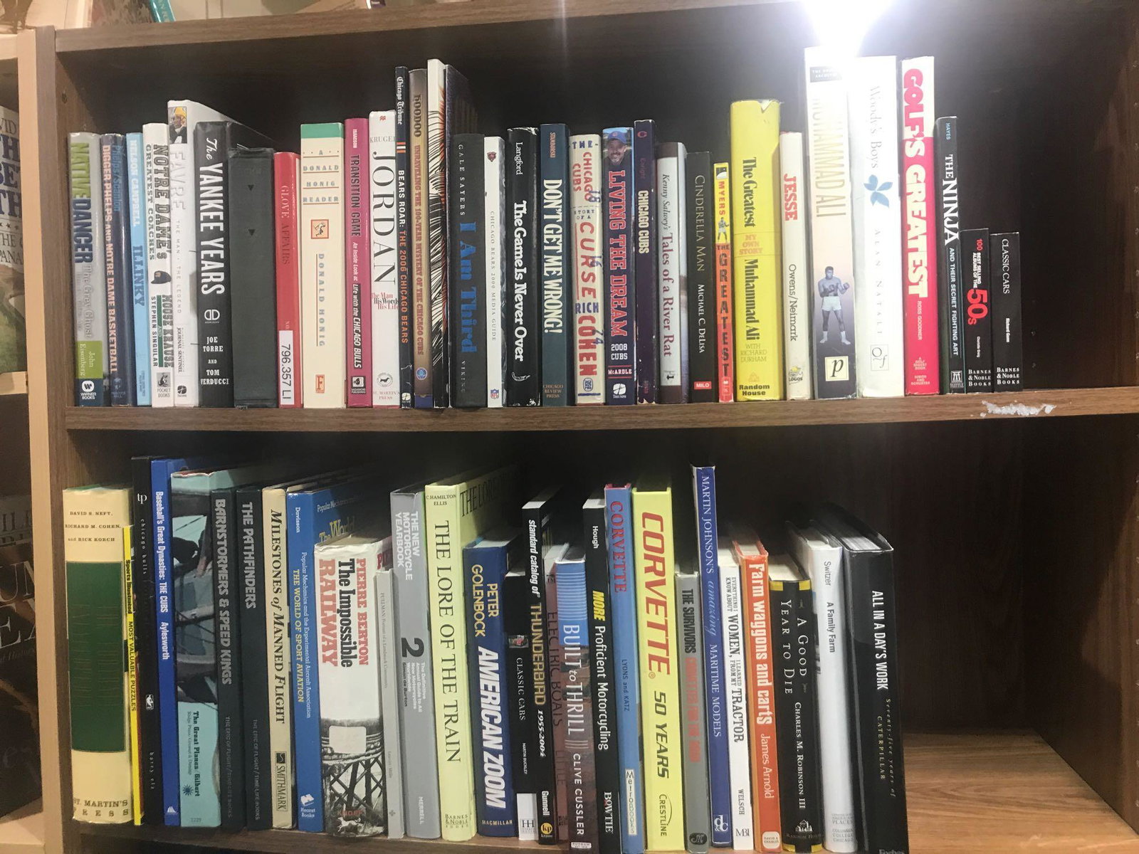 Shelf lot-2 shelves of assorted books: Includes Muhammad Ali, Farve The Man The Legend, The Lore of The Train, Classic Cars and more.