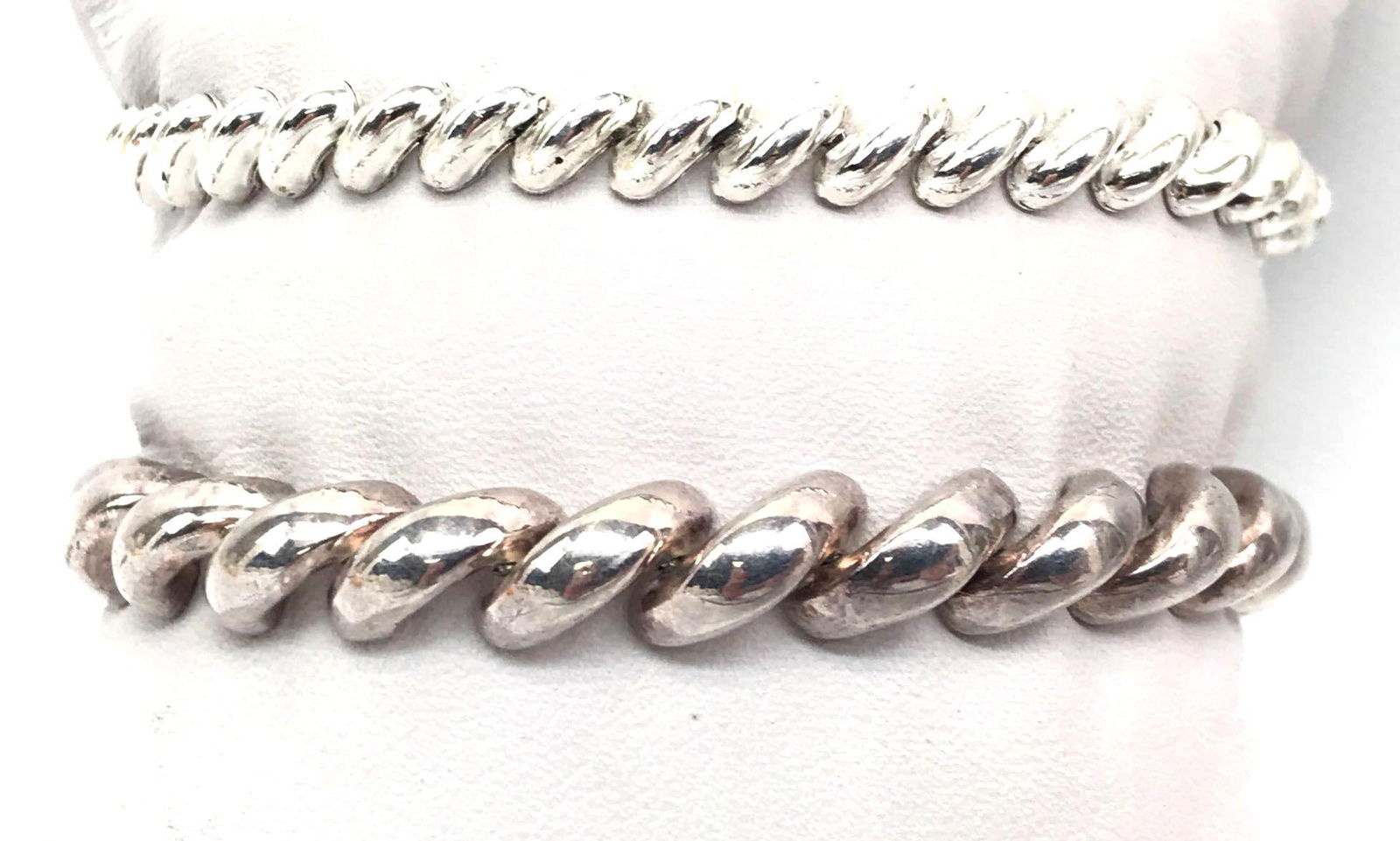 Lot of 2: Sterling Silver Macaroni Link Bracelets: Wider (8mm) sterling silver macaroni link bracelet is marked P.R.EX Italy, secures with a box clasp and safety latch and measures 7 inches. Narrower (5mm) sterling silver macaroni link bracelet is mar