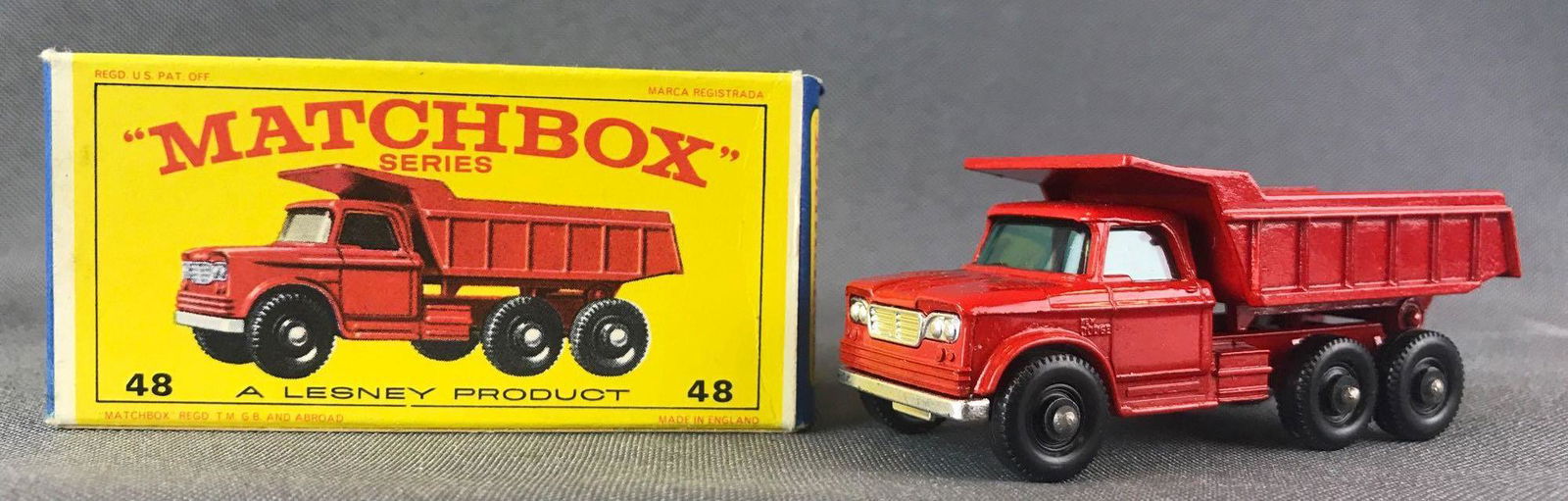 Matchbox No. 48 Dodge Dump Truck Die-Cast Vehicle with: Red body, blue/green windows. BPW. A Lesney Product. Made in England, E Box