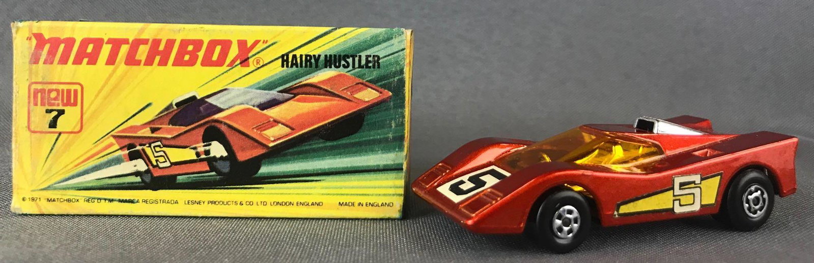 Matchbox Superfast No. 7 Hairy Hustler Die-Cast Vehicle: Orange body, amber windows, BPW, white/yellow/black 5 decals. A Lesney Product. Made in England, I Box