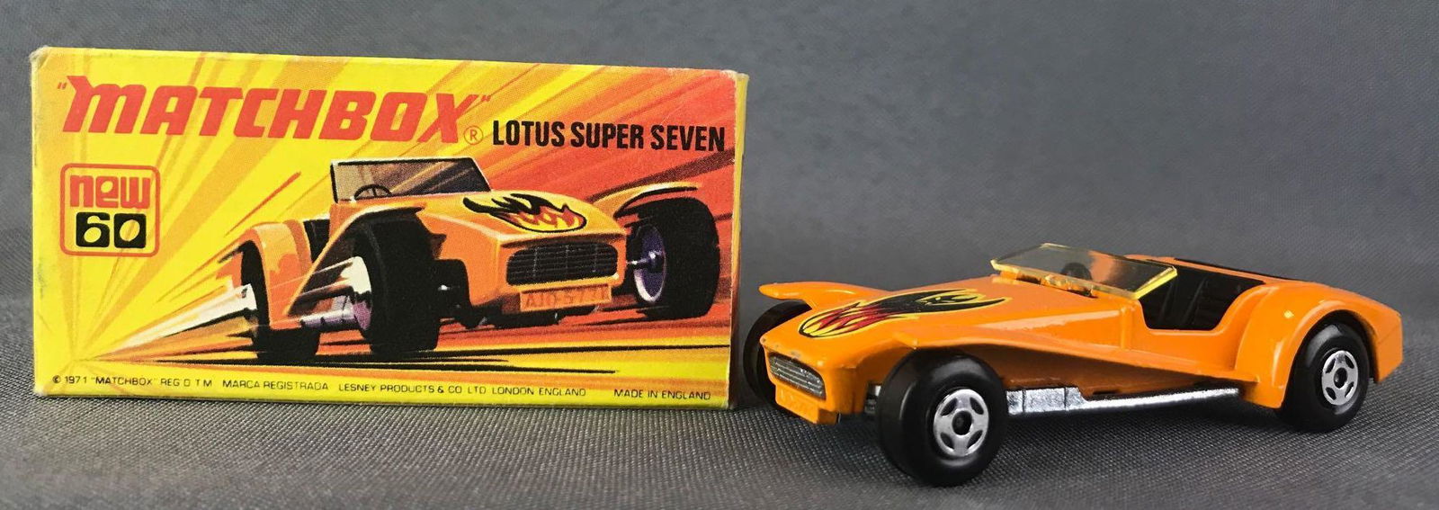 Matchbox Superfast No. 60 Lotus Super Seven Die-Cast: Orange body, amber window, BPW, flame decal. A Lesney Product. Made in England, I Box