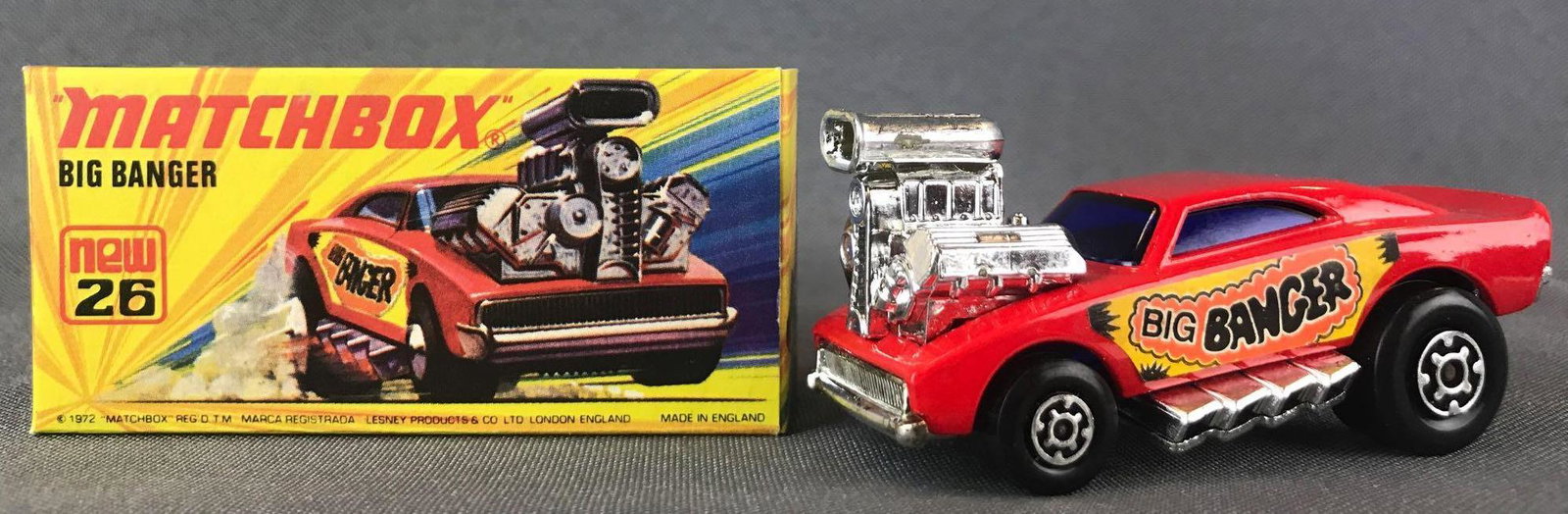 Matchbox Superfast No. 26 Big Banger Die-Cast Vehicle: Red body, blue windows, BPW, yellow/orange/black Big Banger decal. A Lesney Product. Made in England, I Box
