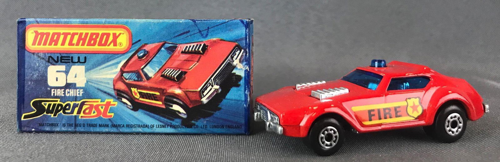 Matchbox Superfast No. 64 Fire Chief Die-Cast Vehicle: Red body, blue windows, BPW, Fire/shield decals. A Lesney Product.ÊJ Box