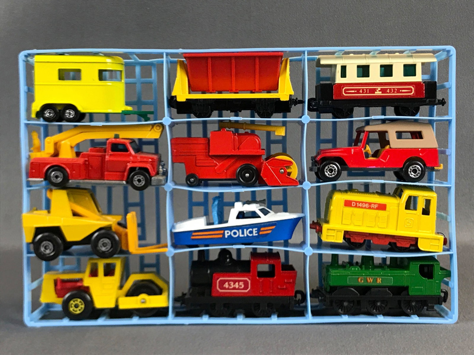 Group of 12 Matchbox Diecast Vehicles with case: Used train engines police boat fire truck horse trailer and more