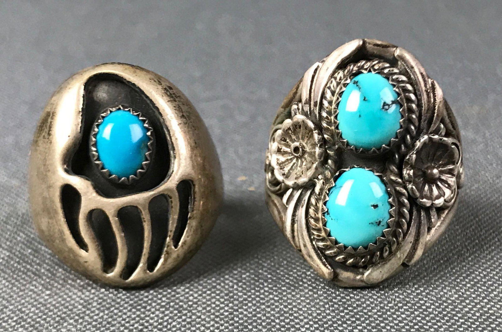 Lot of 2 : Southwest Sawtooth Bezel Set Turquoise Rings: The shadowbox set turquoise "bear claw" ring is hallmarked "B"; the double turquoise stone bezel set ring is marked "sterling".