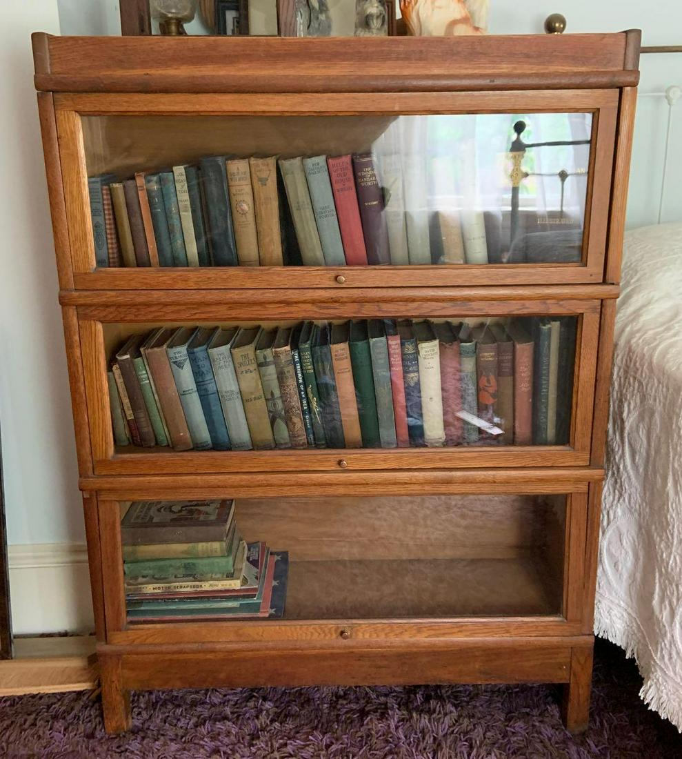 Antique Oak Lawyer Stack Bookcase: 47 x 34 x 10 inches. You are bidding on bookcase only, contents are not included with this lot. Shipping is not available for this lot. Pick up only. (Large or heavy items can be transferred to our Ga