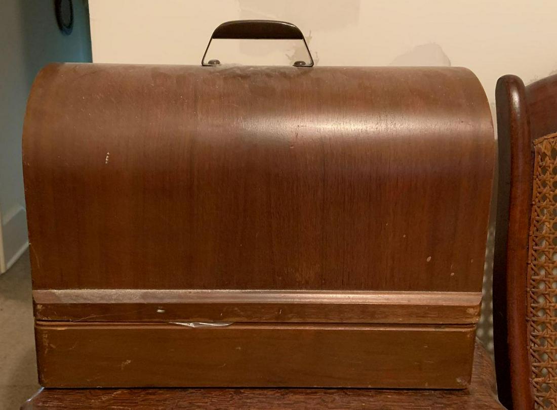 Vintage Sewing Machine in Wooden Case: 17 x 8 x 15 inches. Sewing machine is locked. (Comes with keys, but we were unable to open the case)