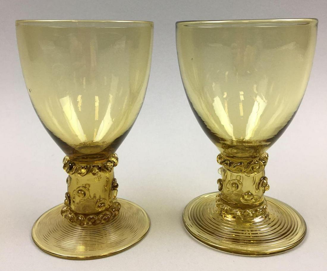 Pair of Steuben Amber Goblets #5067: This striking pair of Steuben Amber Goblets (Carder design #5067) measure 5 3/8 x 3 inches. Both Steuben goblets are in excellent condition with no chips or flaws
