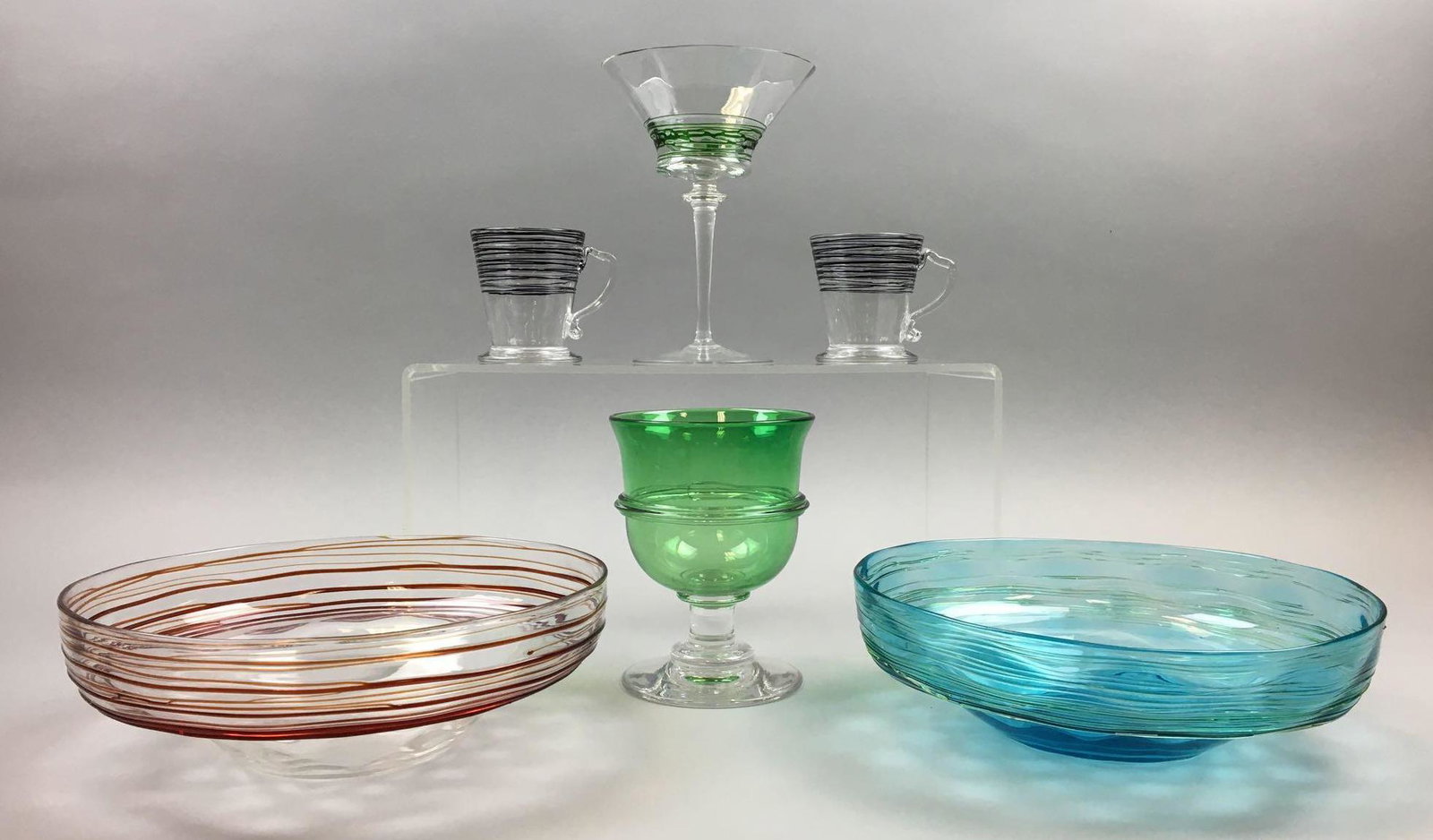 Collection of 6 : Steuben Bowls, Stemware, and Cups: The Bowls in this Steuben group each measure 2-3/4 x 8 inches; The taller stem measures 6-1/2 x 4-1/2 inches; the handled "mugs" each measure 2-3/4 x 2-1/4 inches. Slight interior surface scuffing. Ve
