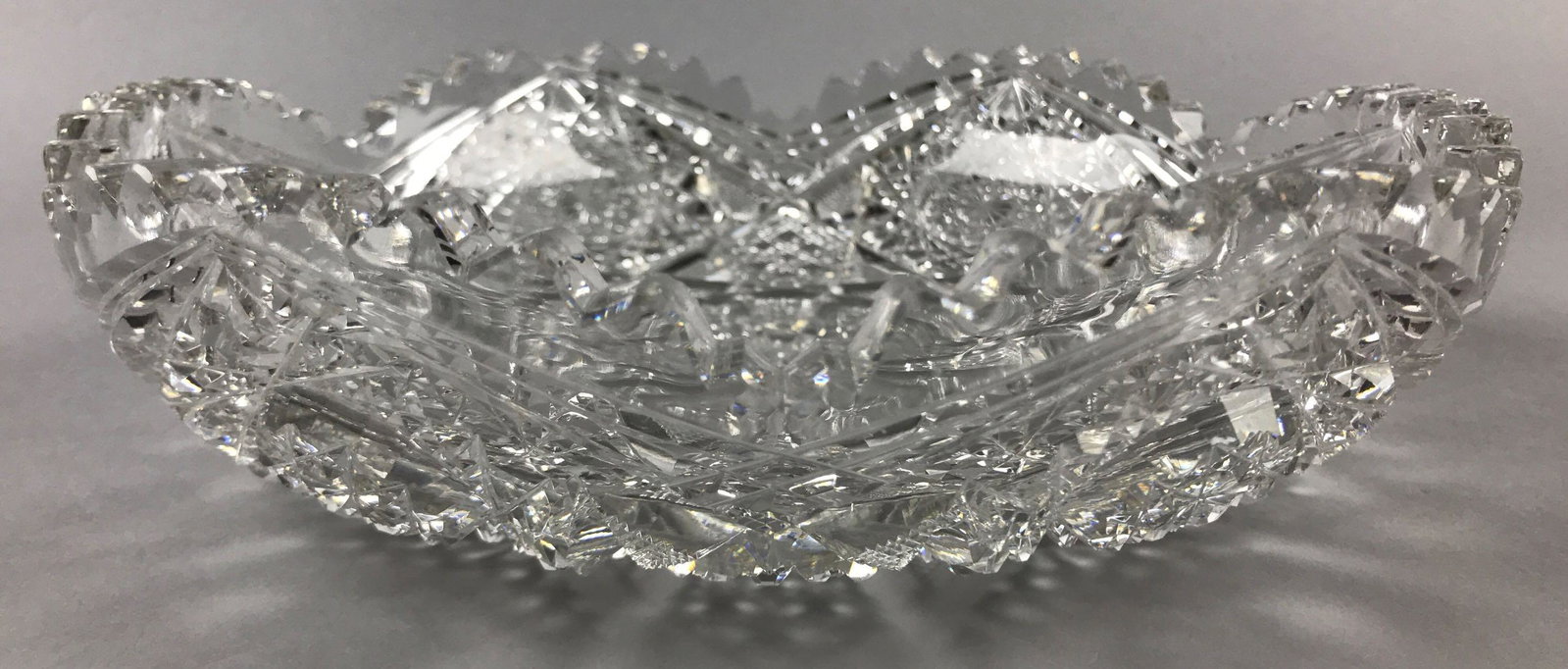 American Brilliant Period Corning Cut Glass Dish: 9 1/2 inch diameter, 2 1/4 inches tall. Some of the maker's mark is illegible - 1852 Corning; flea bites and minimal wear