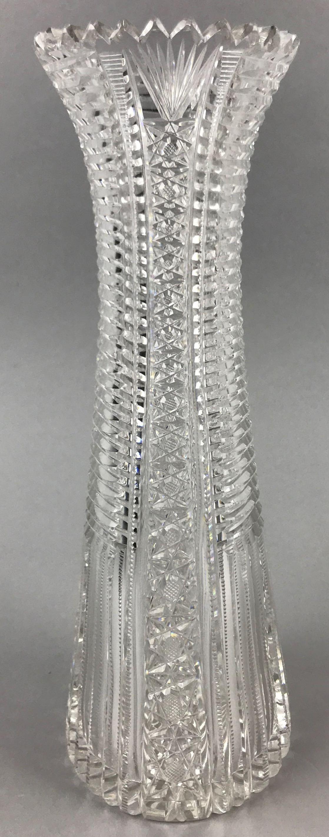 American Brilliant Period Cut Glass Vase: 12 inches tall. Prism star and crosshatch patterns w/ sawtooth rim; minor wear and flea bite chips consistent with age