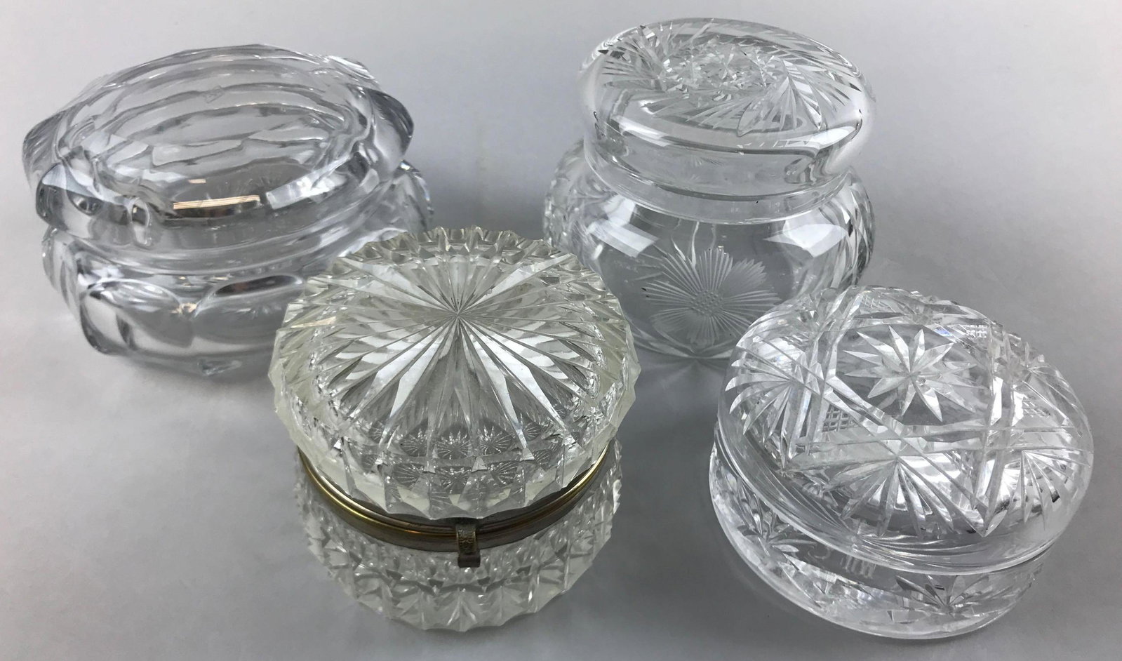 Group of 4 : American Brilliant Period Cut Glass: Tallest jar is 3 inches. Largest jar is signed Heiseywear and chips consistent with age and use