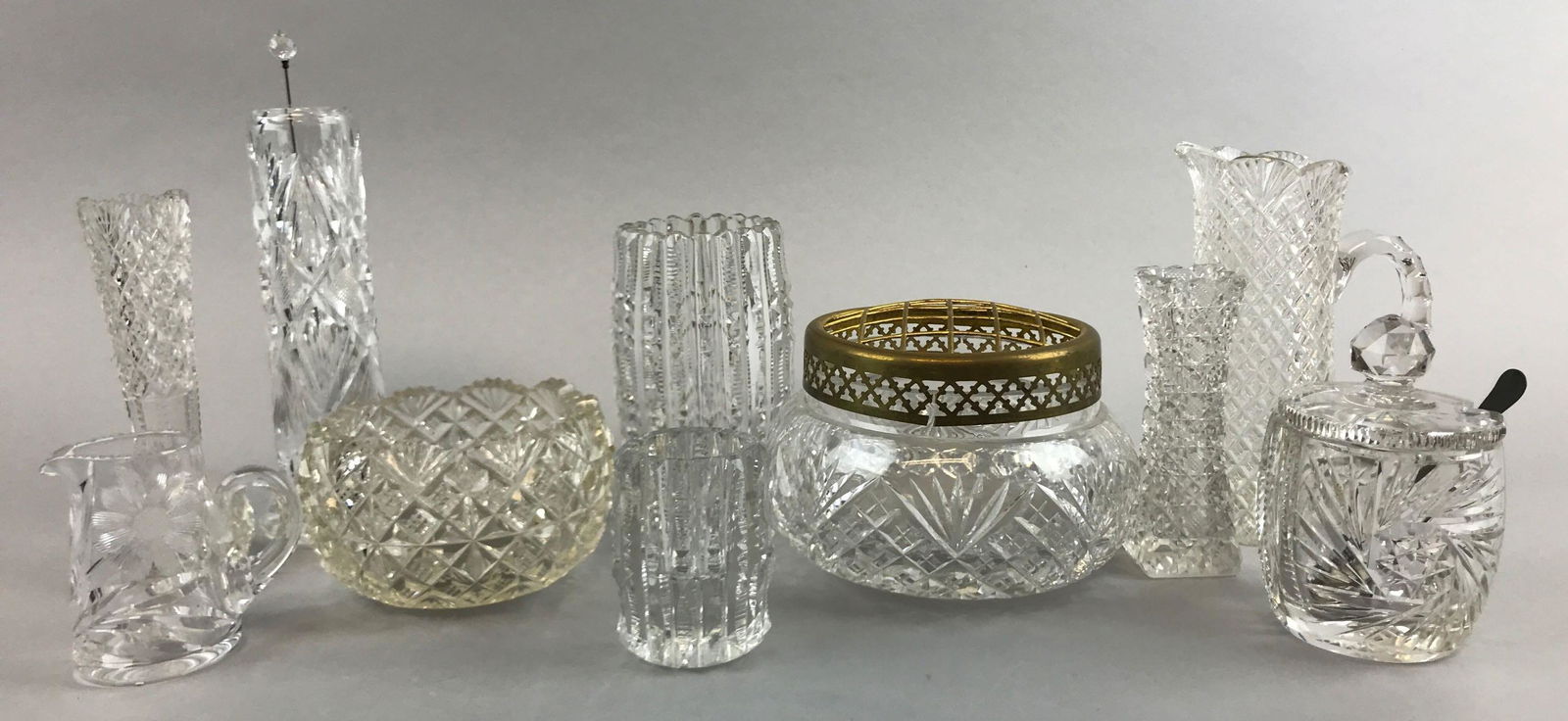 Group of 10 : American Brilliant Period Cut Glass Items: Tallest "hatpin" holder measures 6 1/2 inches. Group includes toothpick holders, vases, cream pitchers and more; wear and chips consistent with age
