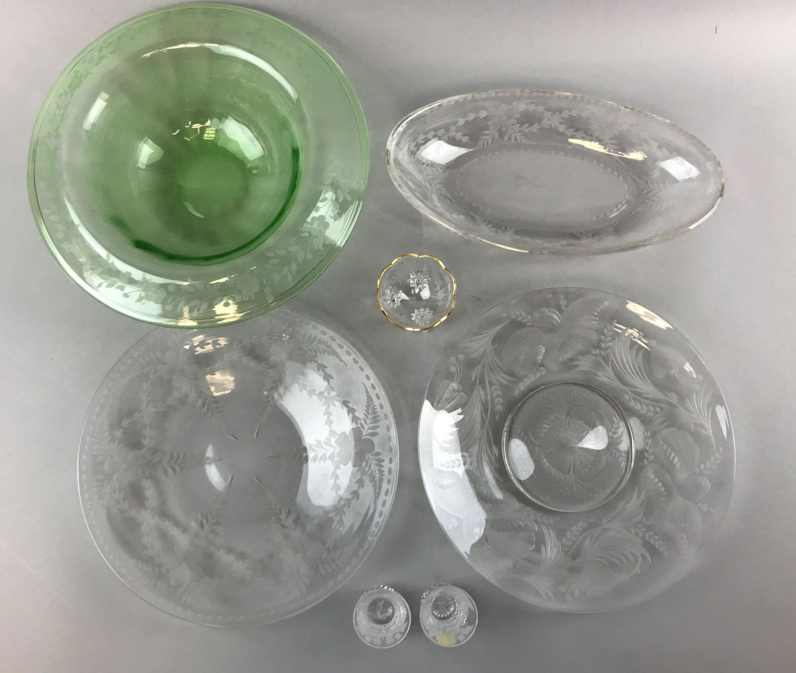 Collection of vintage Cut Glass: Collection includes an 11 inch diameter green bowl and two Edinburgh Crystal "Thistle" pattern shot glasses. One plate in the lot is cracked