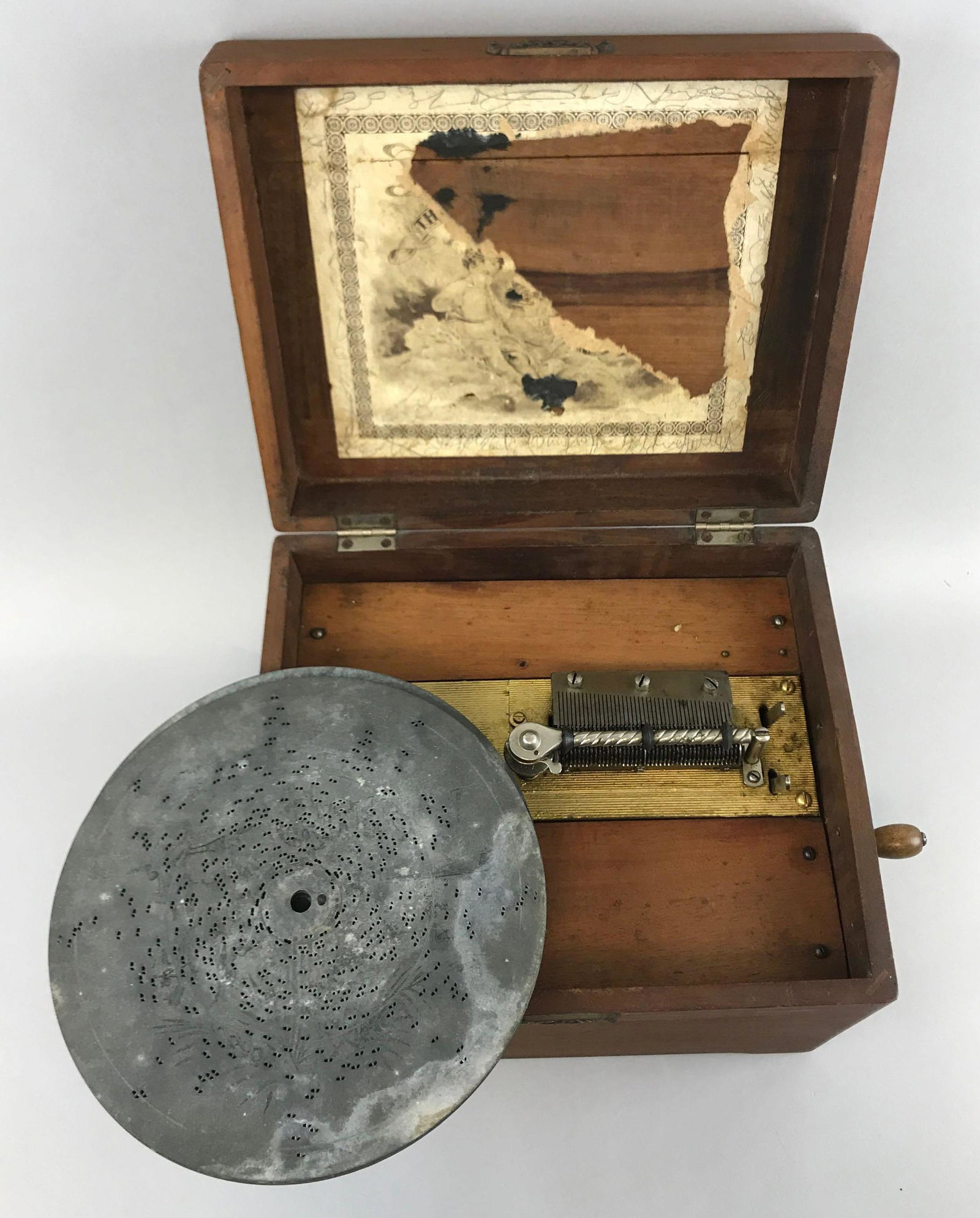 Antique Criterion Music Box: 12 x 10 x 8 1/2 inches; with hand crank. Working condition, with music discs. Discs are warped; does not play perfectly