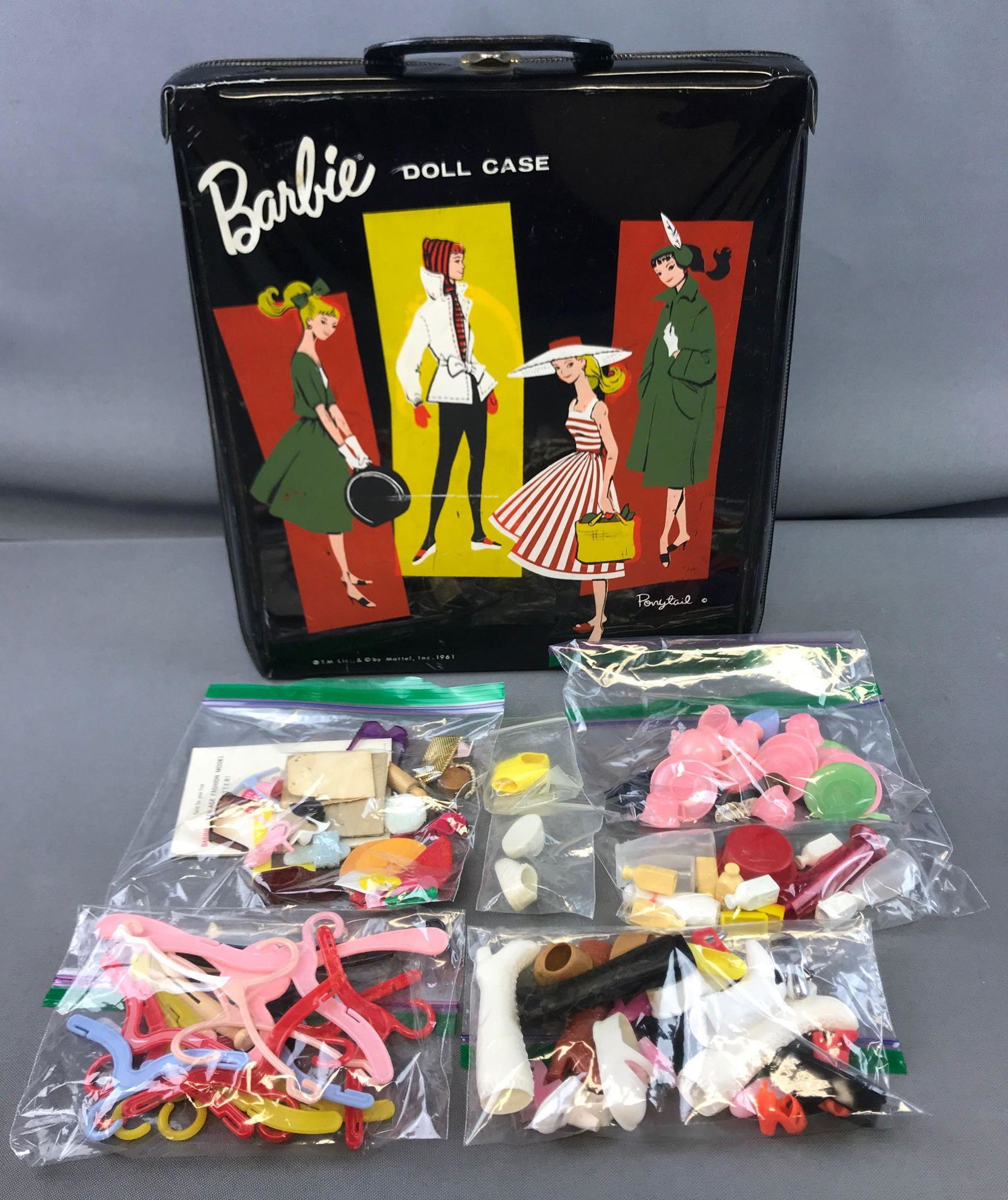 Group of Vintage Barbie Doll Case + Accessories: 10 x 12 inch doll case is dated 1961; hangers, shoes, sunglasses and other doll accessories