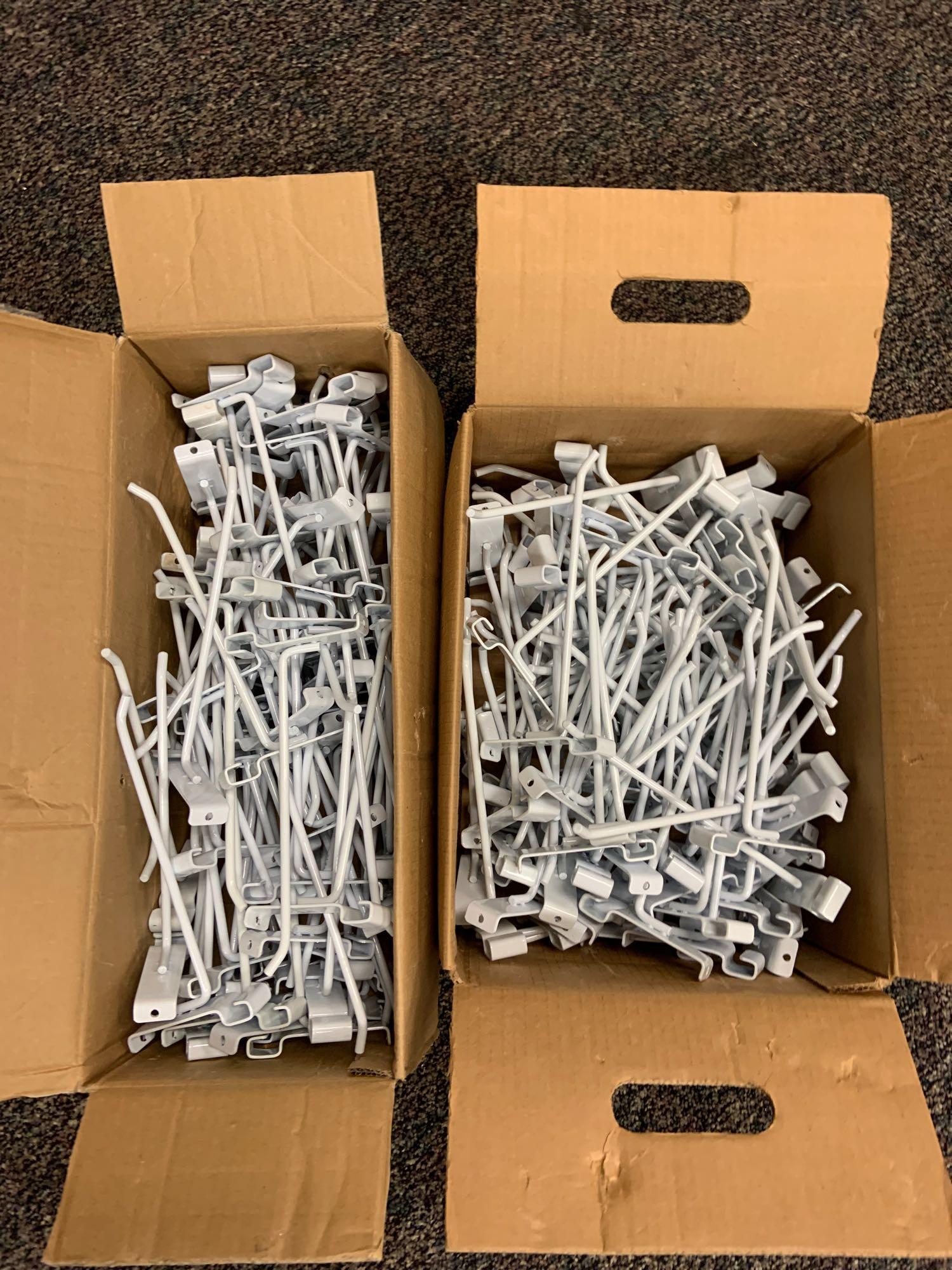 Four boxes of 8 inch white grid wall hooks: 8 inches long