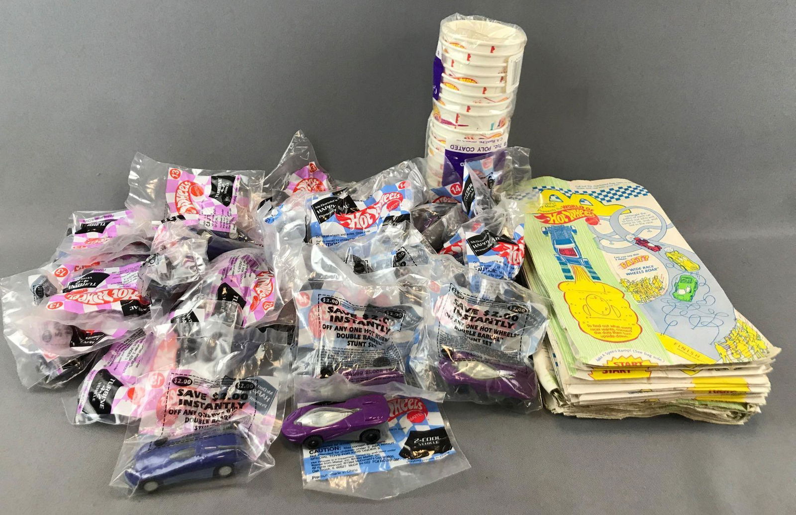 Group of 70+ Pieces Hot Wheels Paper Cups, McDonalds: 2-Cool Vehicle and Turbine 4-2 Vehicle. Bags are 6x11 inches