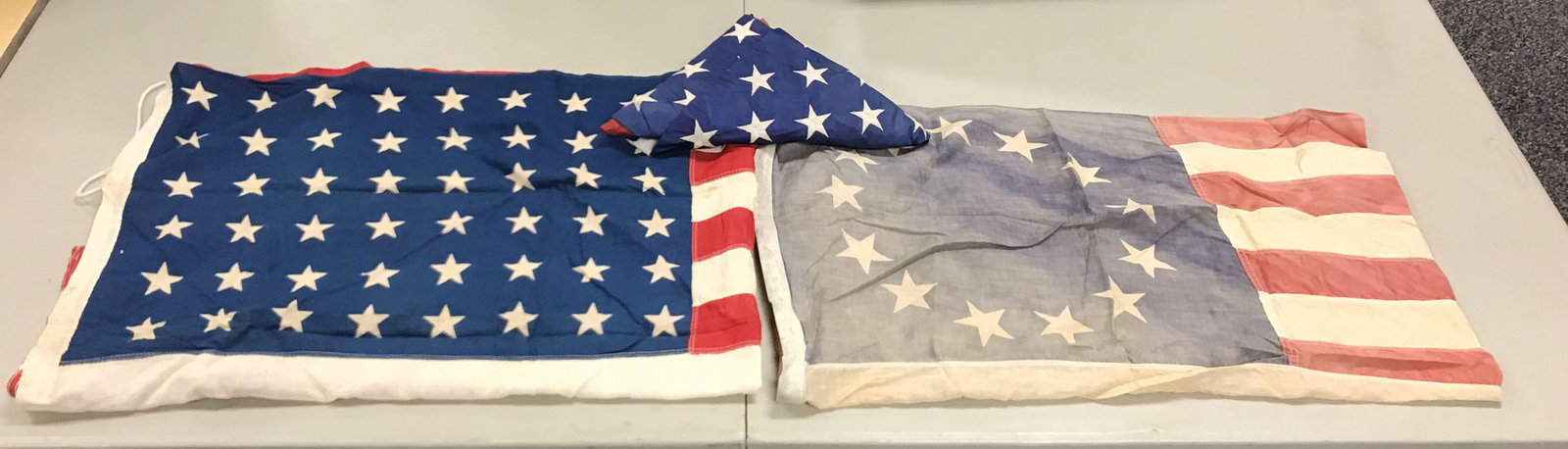 Group of 3 : Vintage American Flags: 13 star flag is 55 x 35 inches and faded. All flags have some wear; 48 star flag has a few holes
