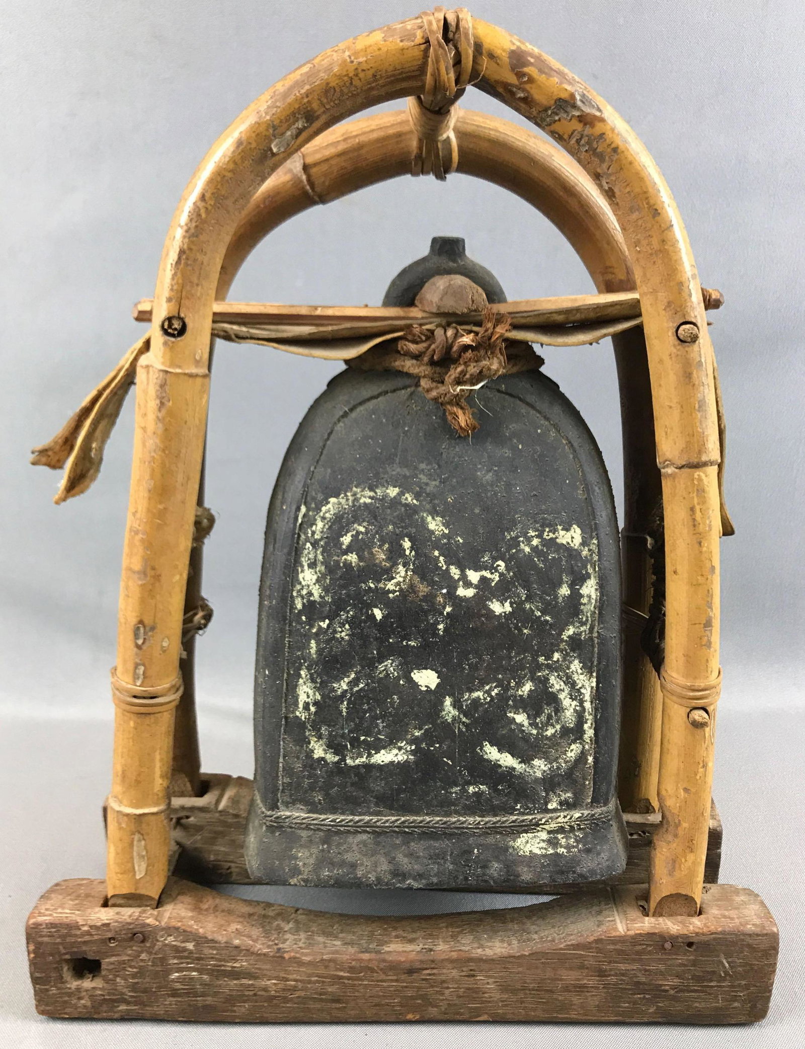 Antique Oriental Bell: 15 x 11 1/2 inches; bamboo, wood, leather primitive housing for large cast iron bell with clapper